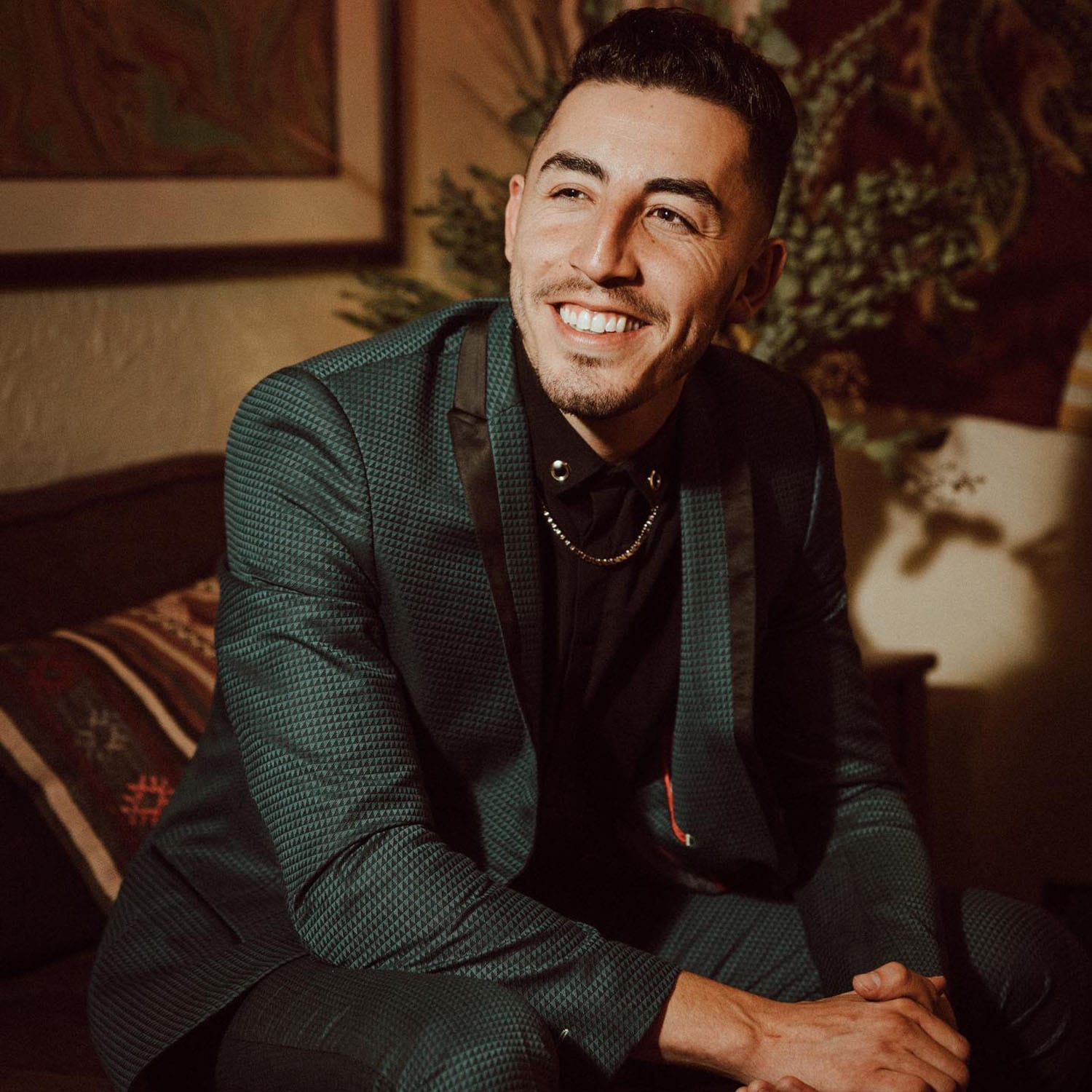 Ricky Duran posing on a chair