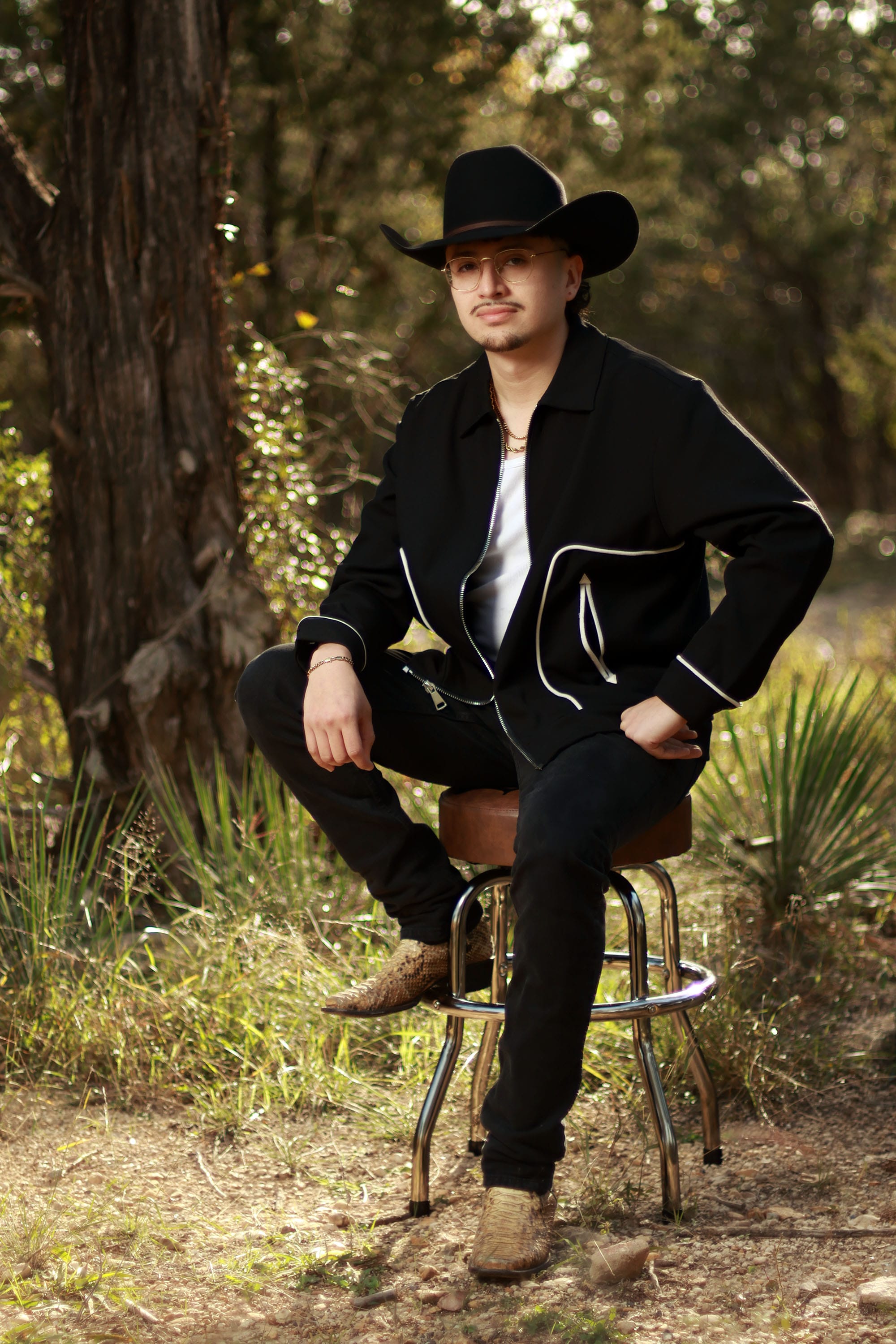 Vinny Tovar sitting in the woods