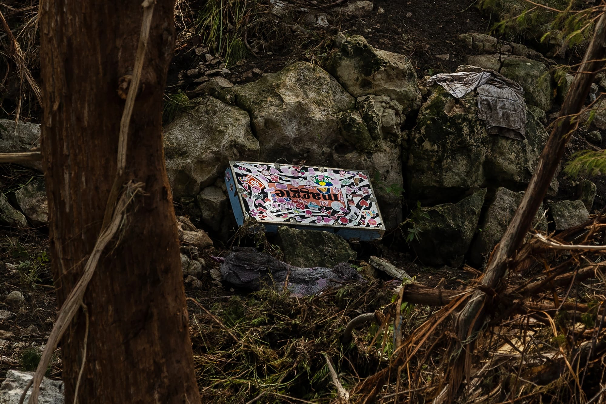 A personalized trunk from a camper at Camp Mystic lays on the bank of the Guadalupe River near Camp Mystic after it was swept up in the flash flooding on July 7, 2025 in Hunt, Texas. (Photo by Jim Vondruska/Getty Images))