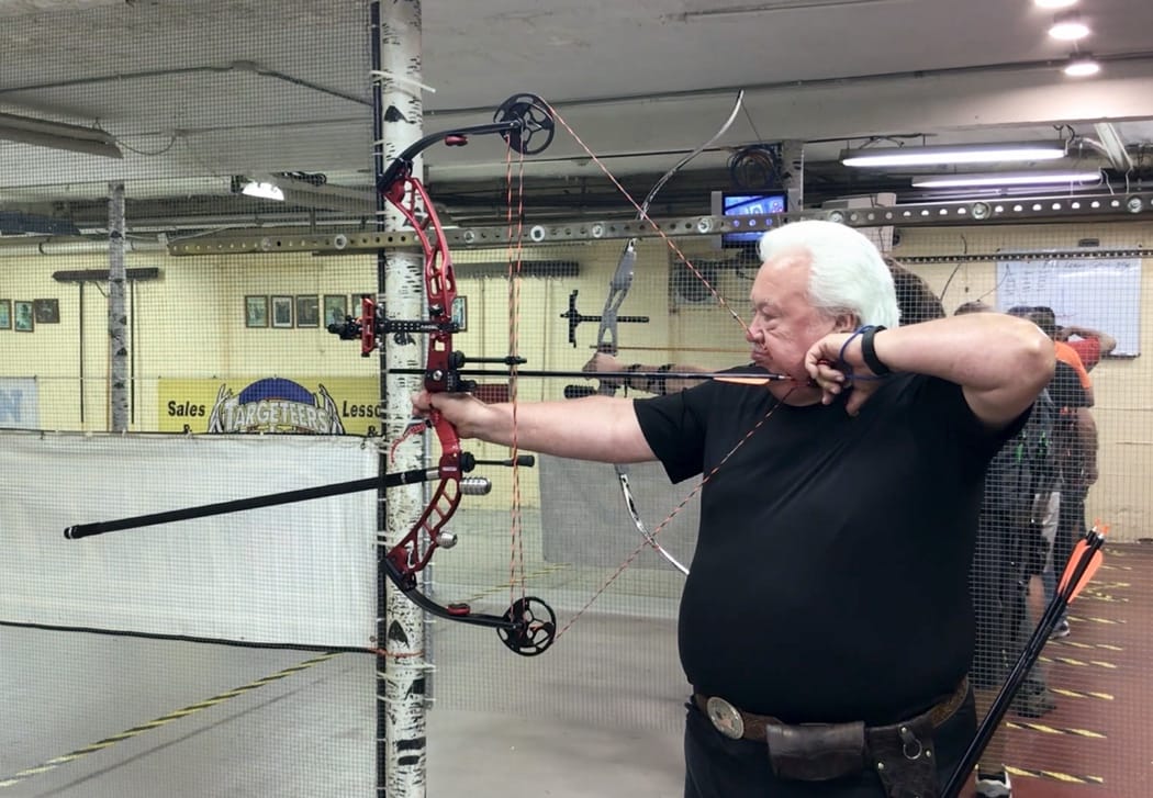 A person shooting a bow and arrow

AI-generated content may be incorrect.