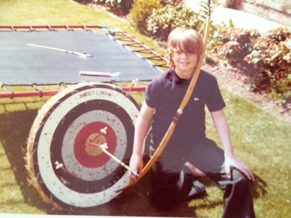A child kneeling next to a trampoline with a bow and arrow

AI-generated content may be incorrect.