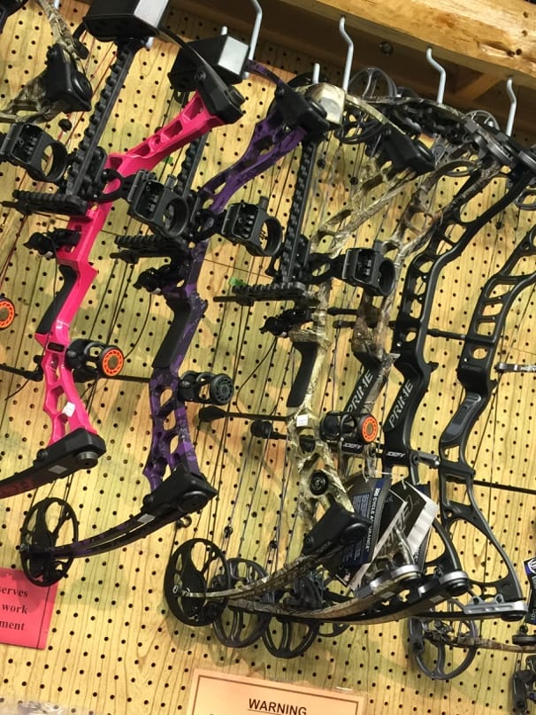 A rack of bows on a wall

AI-generated content may be incorrect.