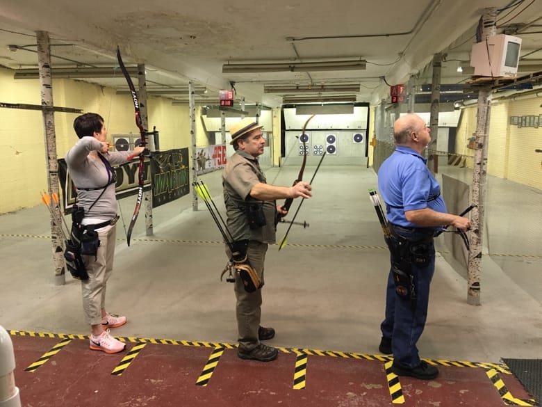 A group of people with bows and arrows

AI-generated content may be incorrect.
