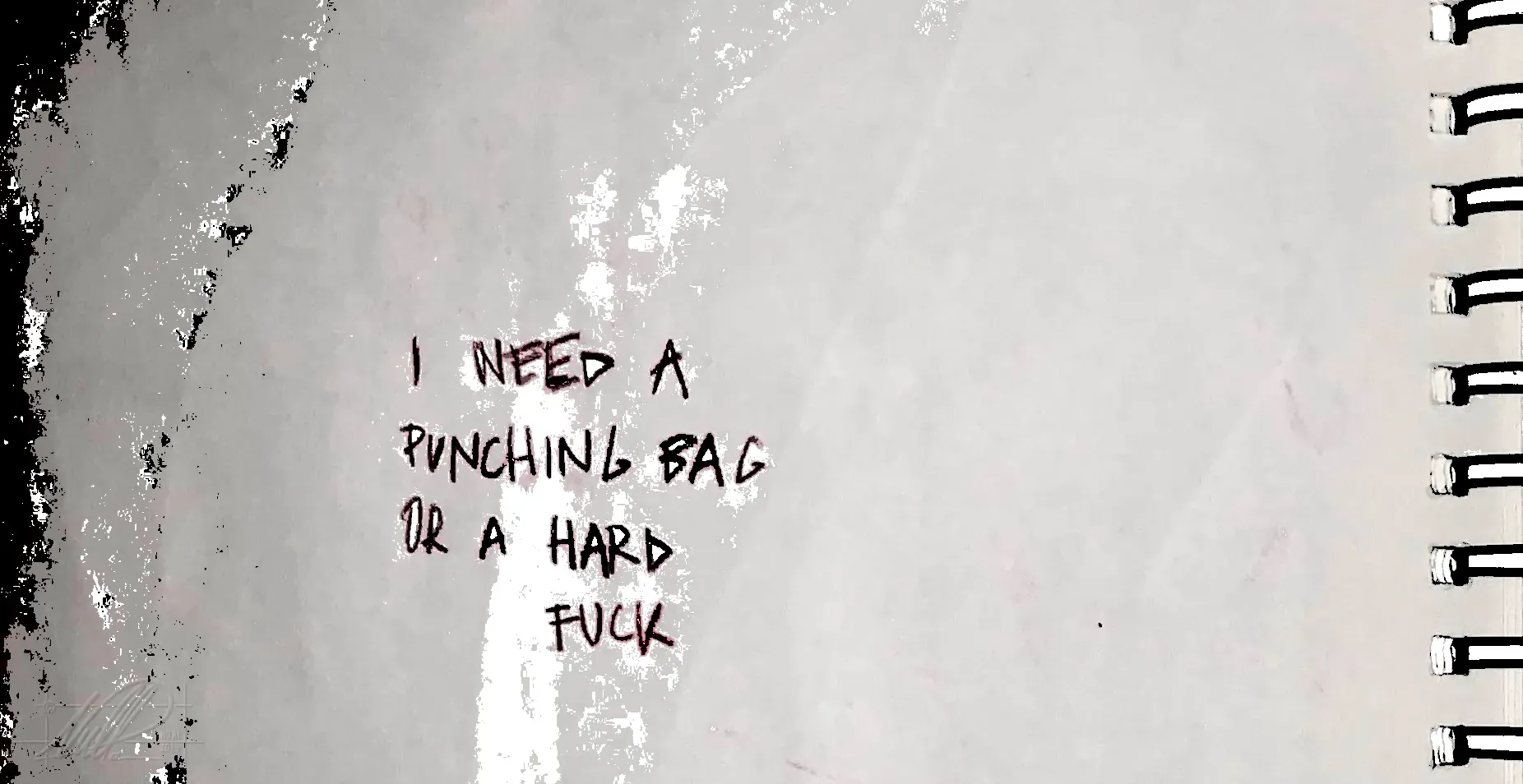 An otherwise blank page with all-caps writing. It reads: "I need a punching bag or a hard fuck."