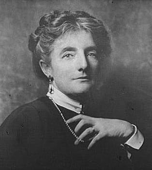 photograph of kathleen norris, author, black and white photo, hair in updo, one hand fiddling with a string of pearls