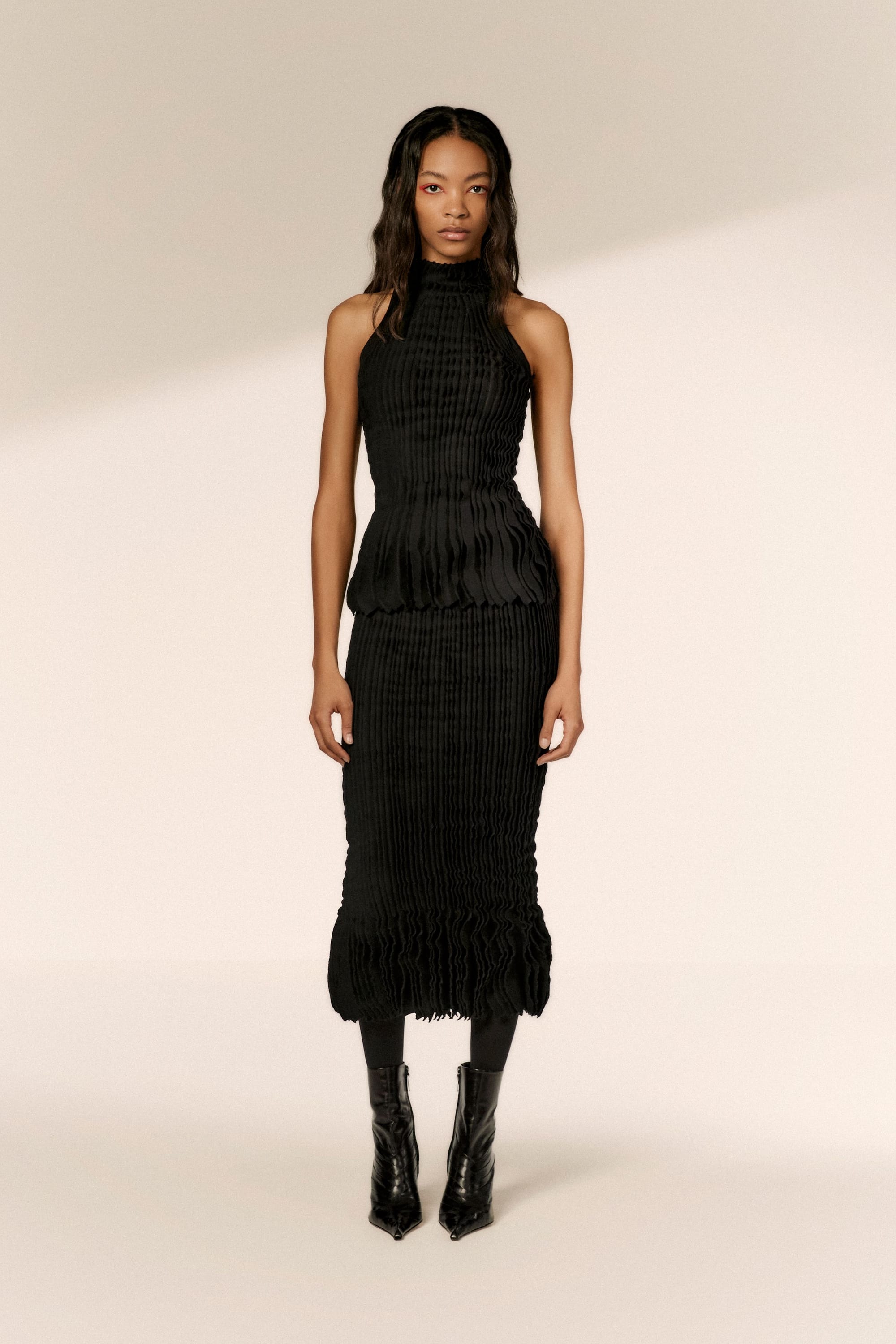 Image may contain Clothing Dress Evening Dress Formal Wear Adult Person Fashion Gown Footwear Shoe and Skirt