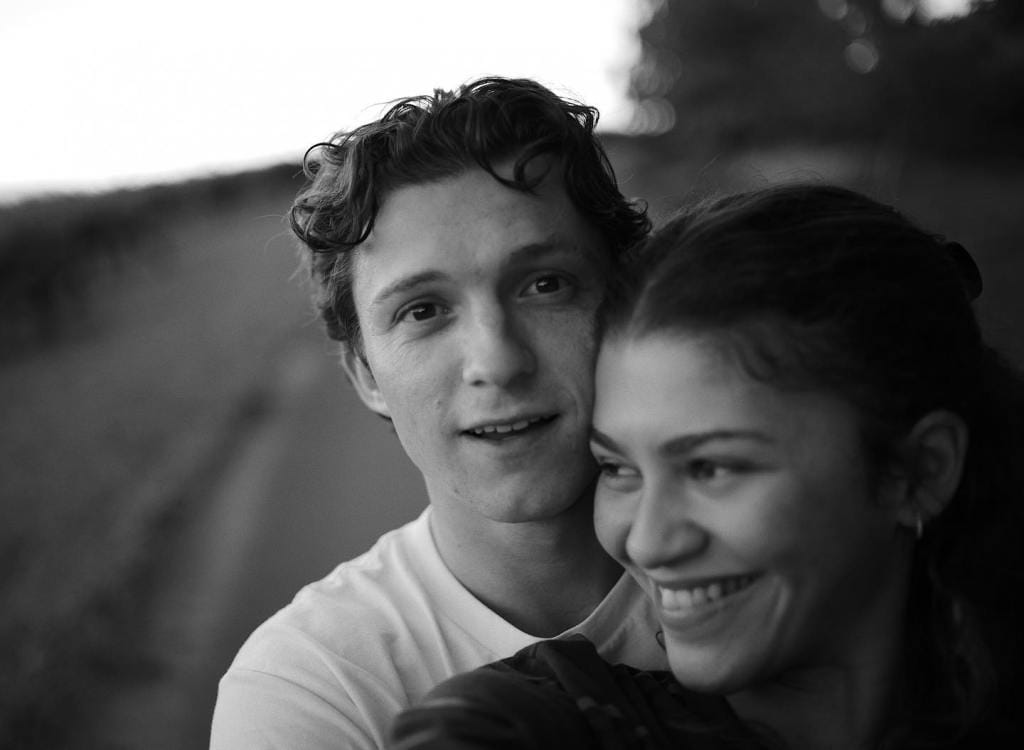 Black and white photo of Tom Holland and Zendaya embracing.