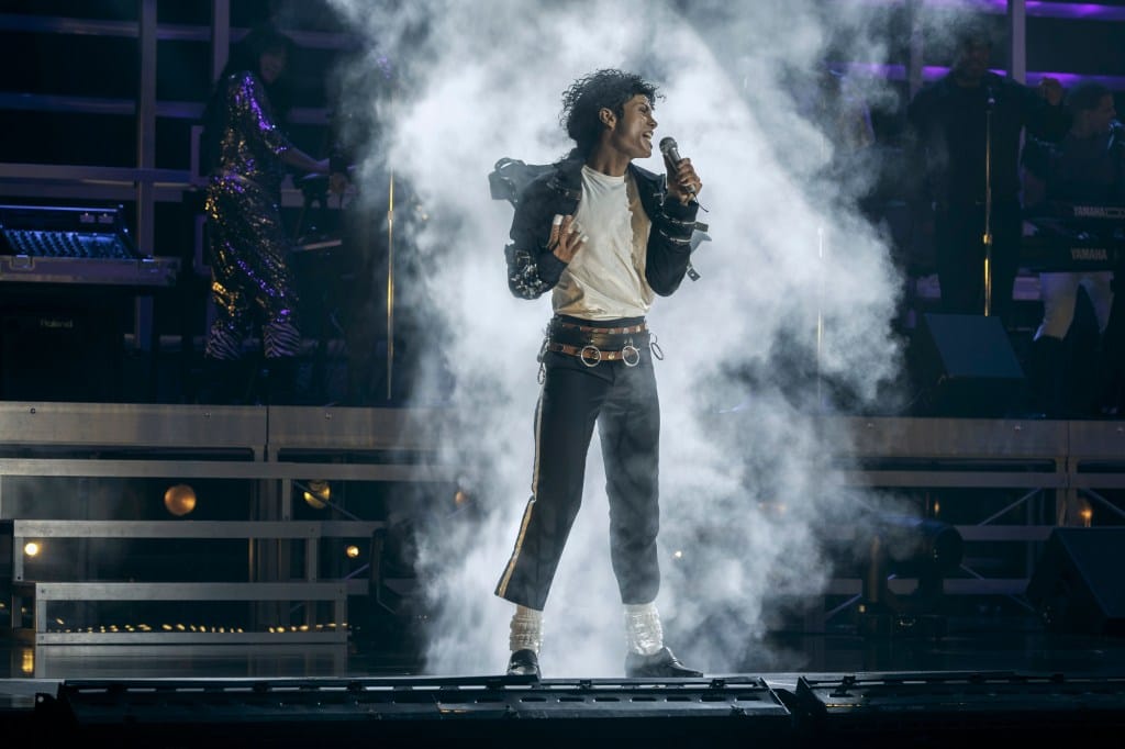 Jaafar Jackson as Michael Jackson in "Michael" performing on stage amidst smoke.