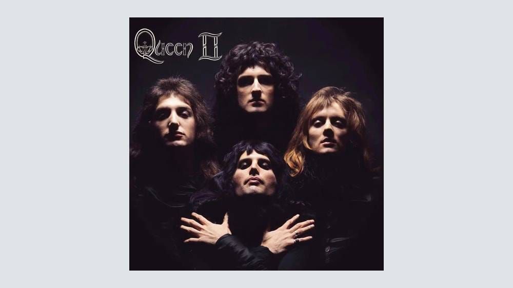 The Queen II album cover — the iconic black-and-white portrait of the four band members shot by Mick Rock — or a photo of the deluxe boxed set itself showing the packaging and archival mat...