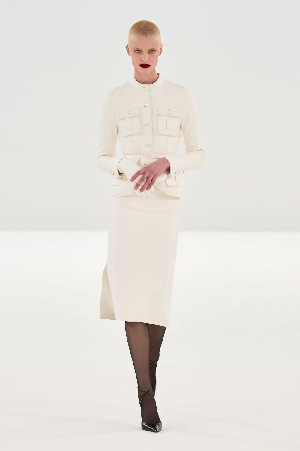 A single look from the Tom Ford Fall 2026 runway—ideally a sharply tailored blazer or body-conscious evening dress—that captures the polish and technical execution but also the slightly an...
