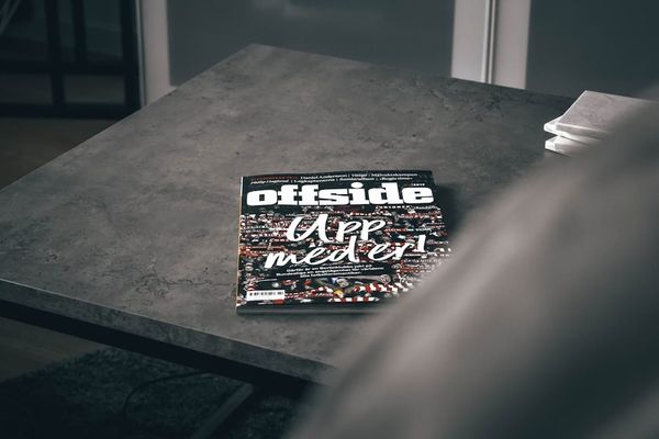 Stack of independent print magazines on a coffee table