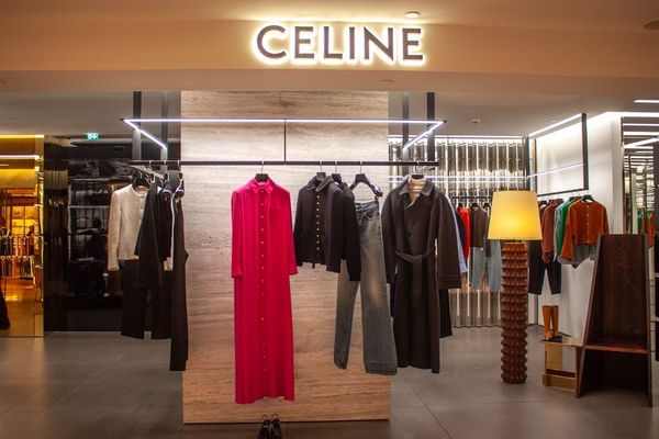 Curated rack of designer clothing in a luxury resale setting