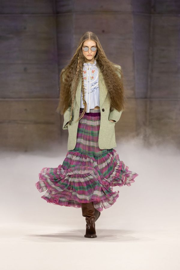 A runway look from Chloé Fall 2026 — ideally one of the opening suede coats or a flowing silhouette that captures the 1970s bohemian codes Kamali is mining. Should feel soft, neutral-toned...