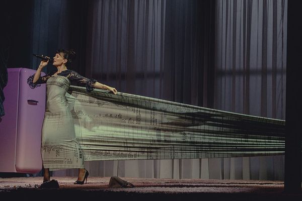 Lily Allen performing on stage during the West End Girl tour, ideally a moment of emotional intensity — solo spotlight, minimal production, direct connection with audience visible