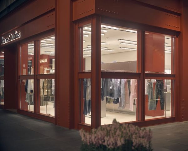 A modern storefront with large glass windows at night