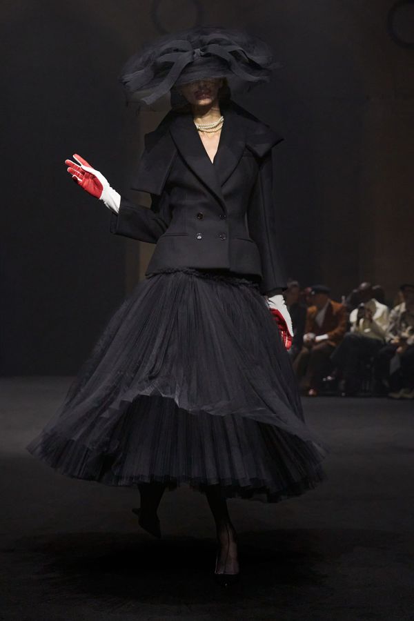 A runway image from the Fall 2026 collection showing one of the deconstructed outerwear pieces or asymmetric tailoring—ideally a look that demonstrates the technical sophistication and arc...