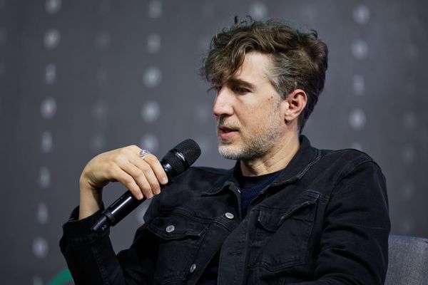 A photo of Moxie Marlinspike at a tech event or speaking engagement, or a visual representation of encryption technology/Signal's interface alongside Meta's branding