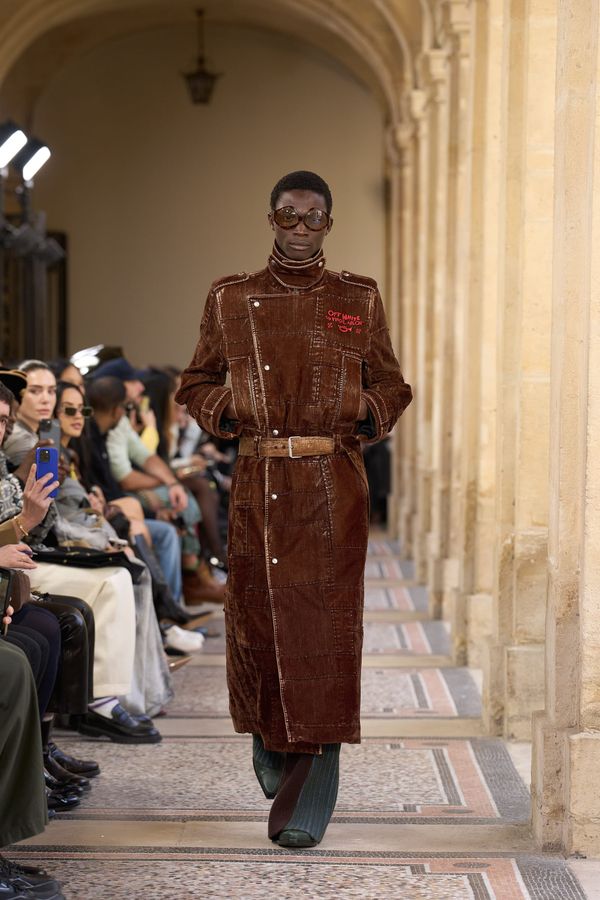 A runway shot from Off-White Fall 2026 showing the refined tailoring and elevated aesthetic—ideally the opening white shirt look or a piece that demonstrates the shift toward wearable luxu...