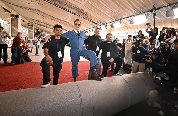 Wide shot of the Oscars red carpet setup outside the Dolby Theatre, showing the infrastructure, barriers, and security presence — ideally from this year's event or recent ceremonies. The i...