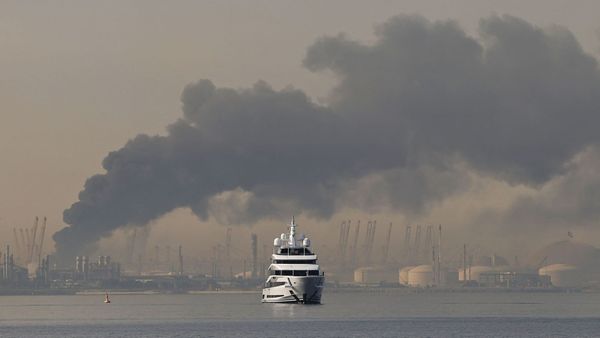 A map showing the Strait of Hormuz with shipping routes overlaid, or a wide shot of stacked shipping containers at a port — something that visualizes the scale and logistics of global fash...