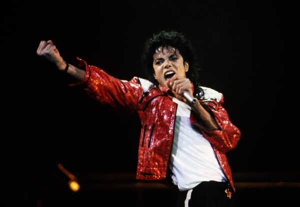A still from the Michael biopic showing the concert sequence that replaced the abuse allegations, or archival footage of Jackson performing—the image the estate paid $15 million to make de...