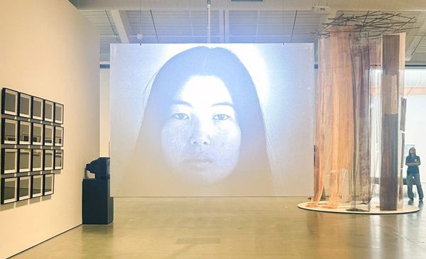 Installation view from the Berkeley Art Museum exhibition showing one of Cha's video works or text-based pieces in the gallery space, or an archival photograph of Cha herself from the earl...