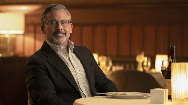Steve Carell in a scene from Rooster—understated, emotionally present, not performing comedy in the traditional sense. Alternatively, a photo of Carell at an Emmy ceremony, positioned as a...