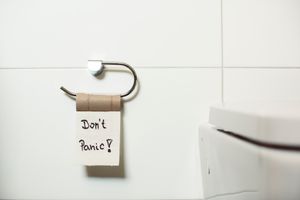 An empty toilet roll with the words Don't panic written on it