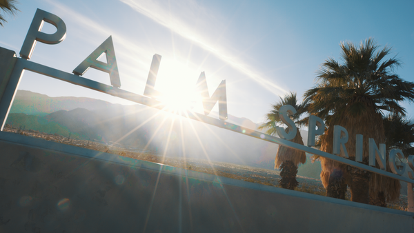 Sunset behind the Palm Springs sign at the north entrance to the city.