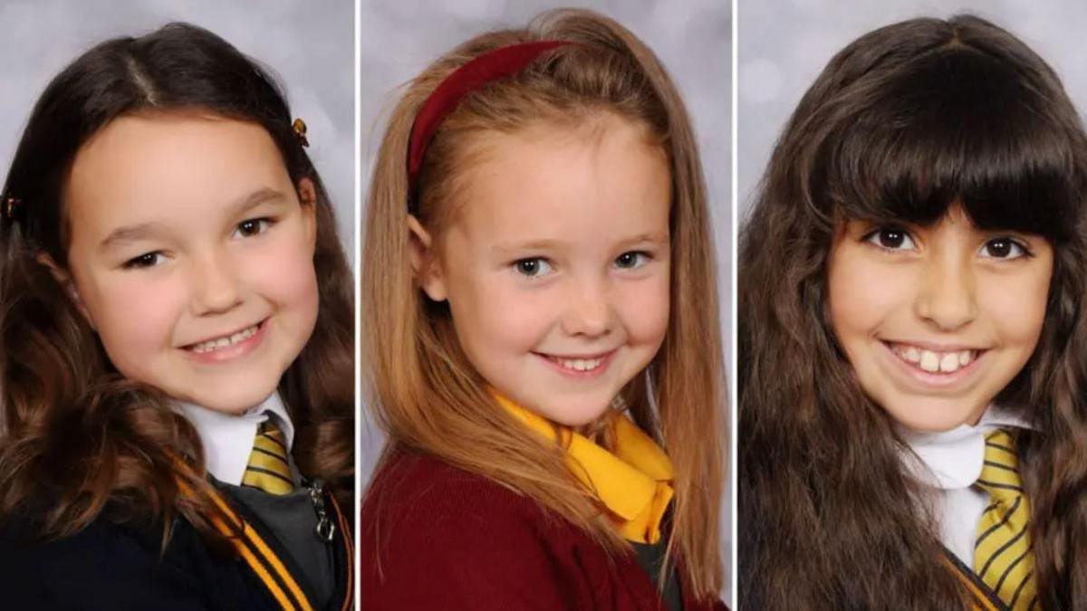Left to right: Bebe King, Elsie Dot Stancombe and Alice Aguiar in school uniforms. They are all smiling.