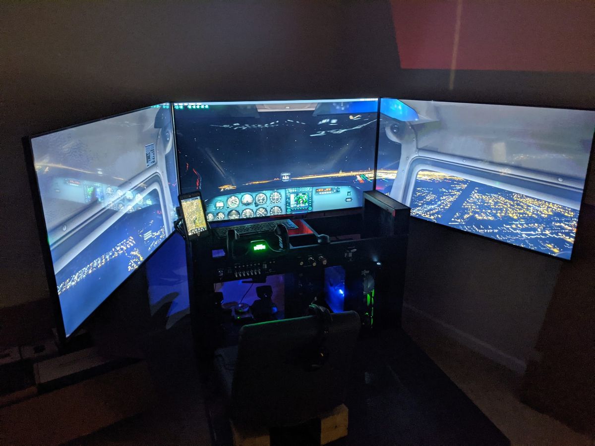 Photo of a Cessna 172 home flight simulator in unlit room during a night flight in X-Plane.