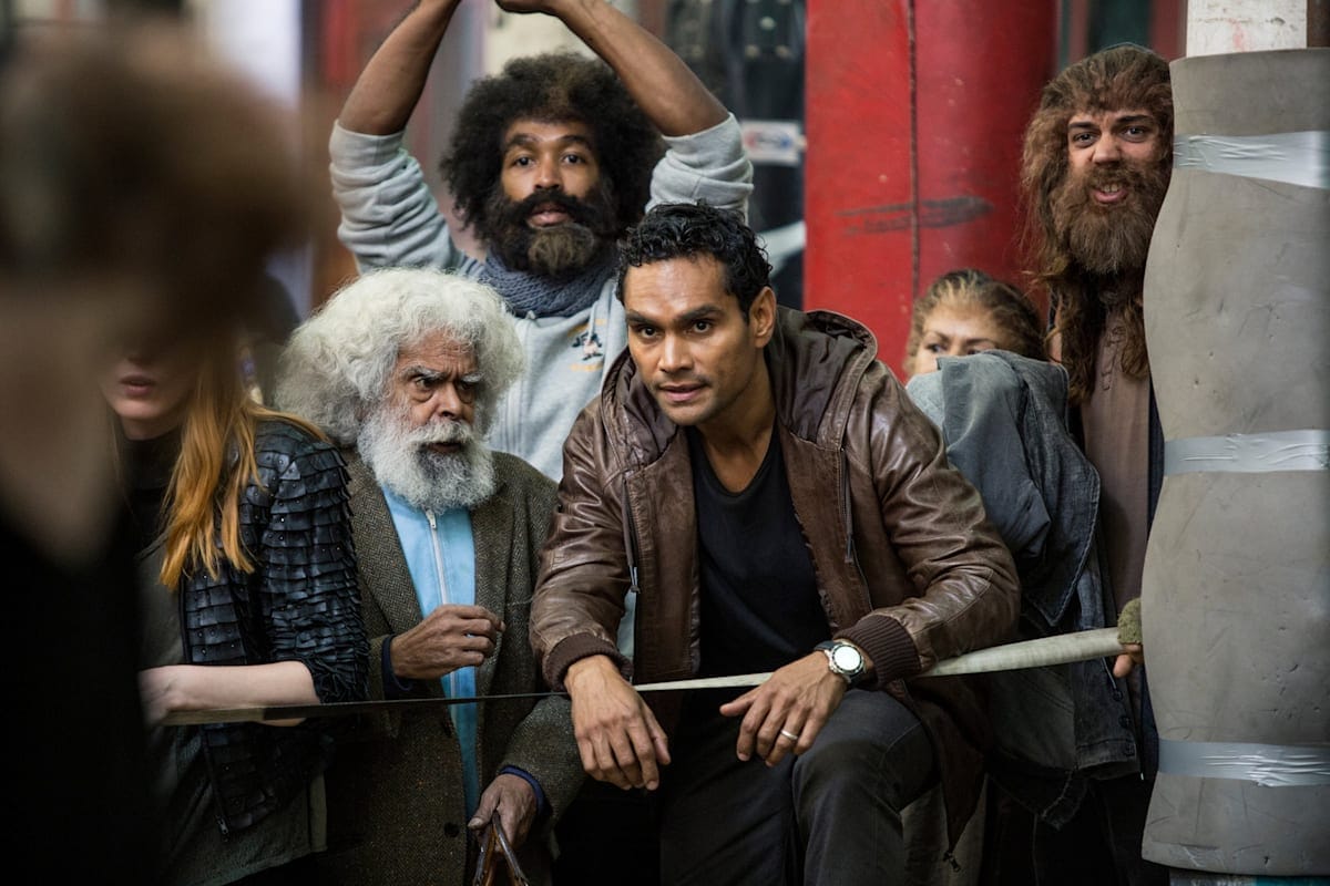 Two characters in a group face the camera in the TV show Cleverman 