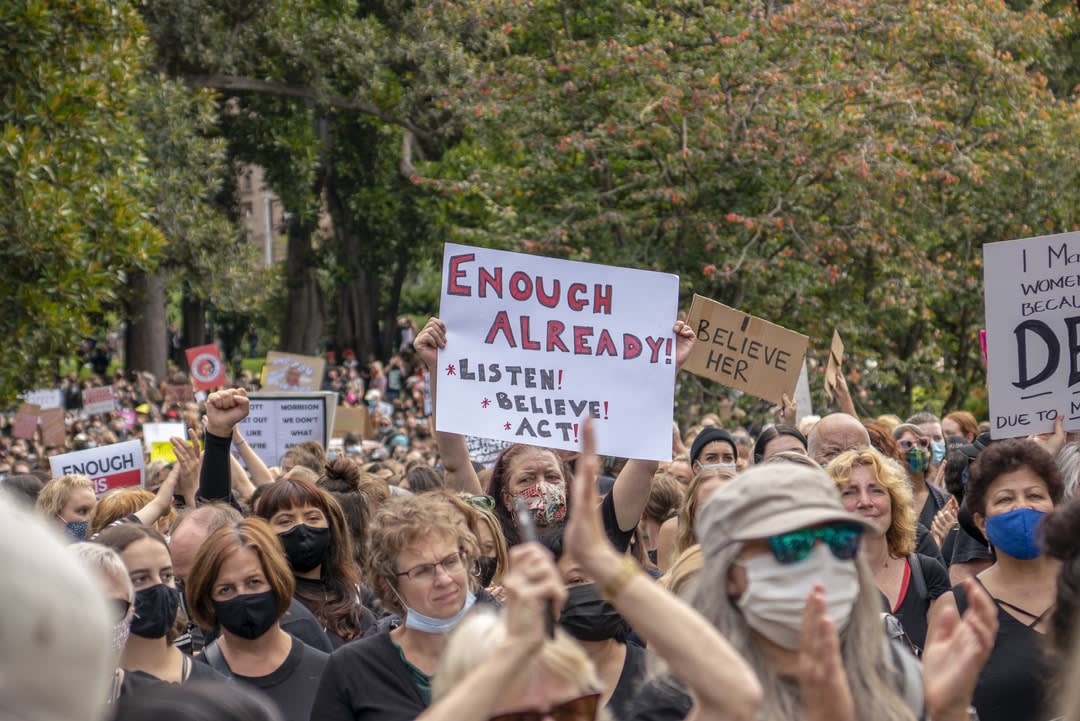 Protesters with signs at Melbourne
