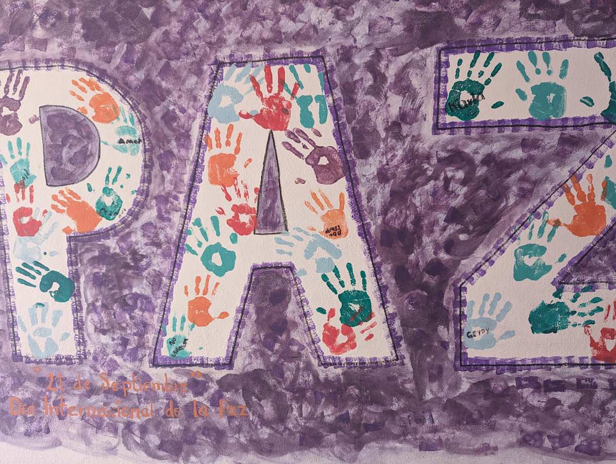 A mural reading “PEACE” in Spanish at a shelter for survivors of intimate partner violence in Mexico. 