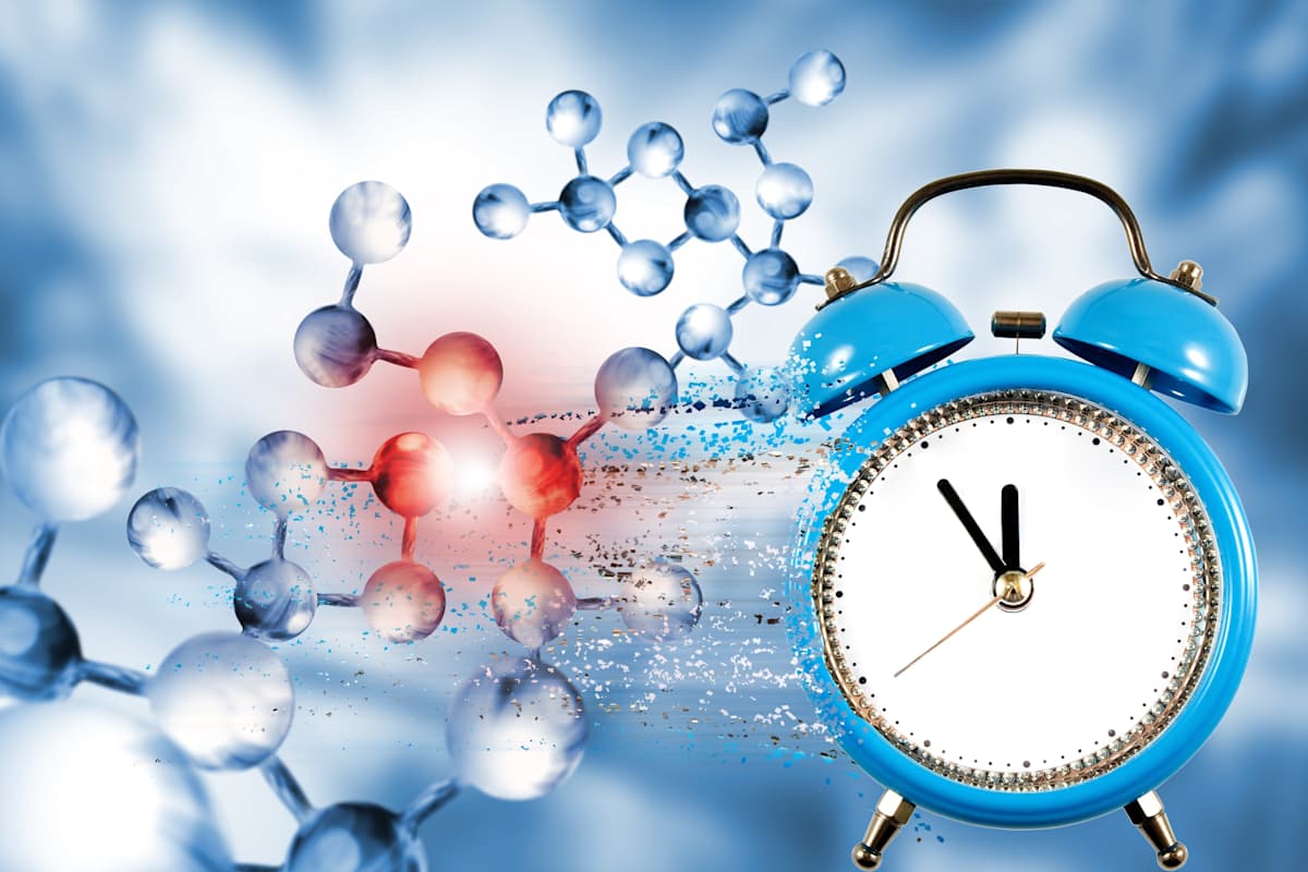 image of dna chain on biotechnological background and a clock with particles decaying on one side.