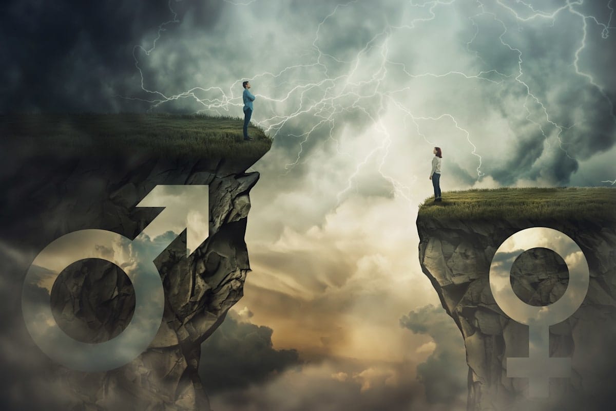 Gender gap idea and sex inequality concept as male and female sign shaped into stone cliffs of different sizes as a metaphor of social inequity 