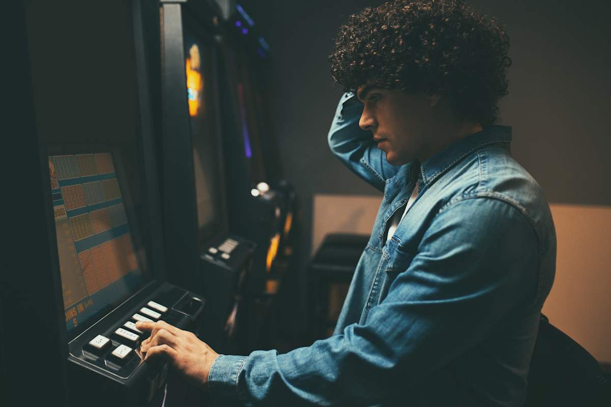 Young man playing the pokies