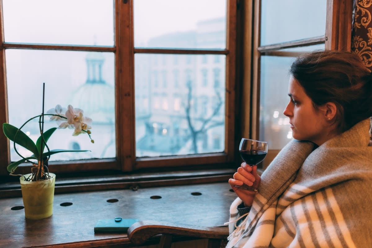 woman in pandemic lockdown drinking wine