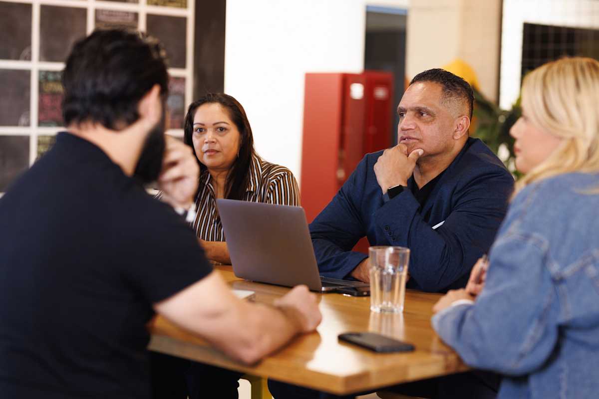 Indigenous man leads a meeting.