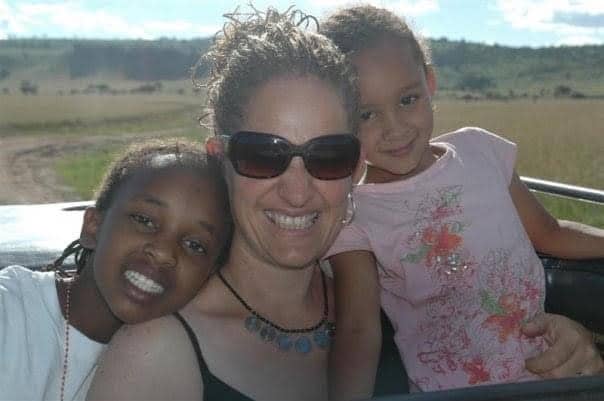 Smiling group shot of Jomo Kigotho’s cousin,&nbsp;Maureen (left), mother Ruth Rowlands, and younger sister Malaika, in Kenya.&nbsp;
