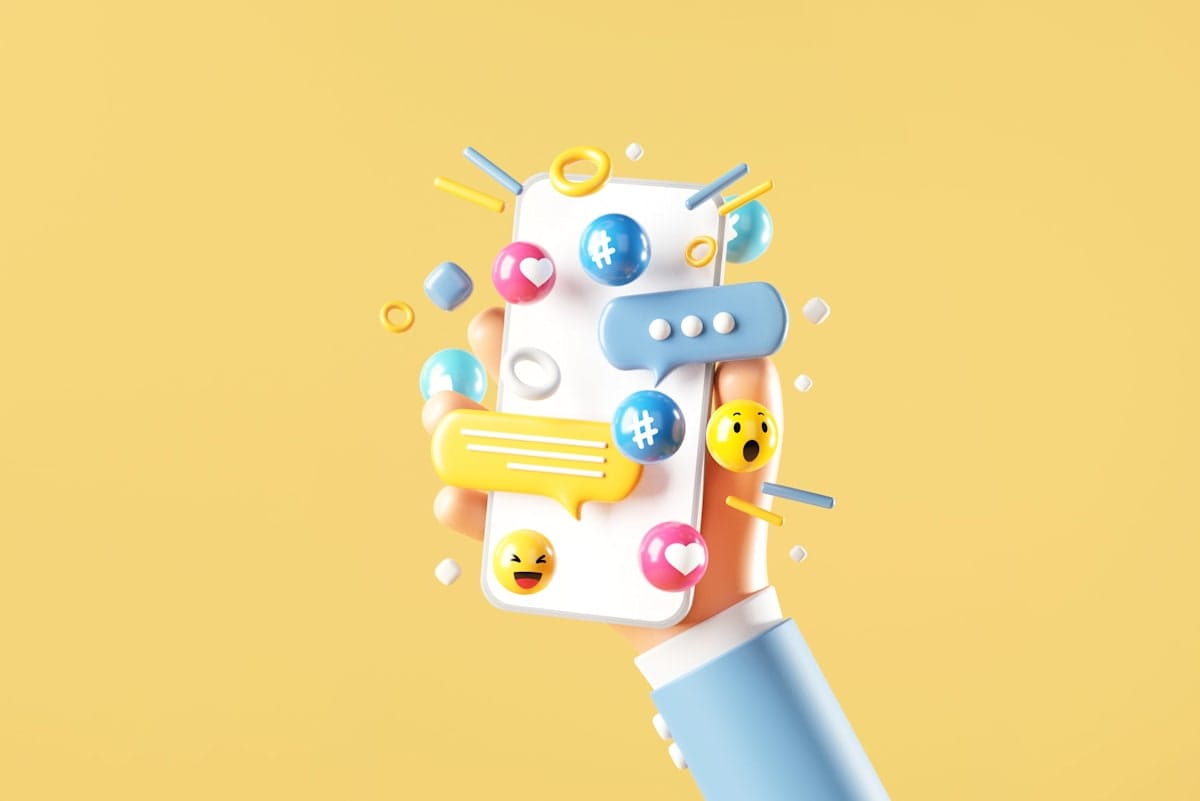 Rendering of a hand holding blank mobile phone with love, like, comment, hashtag button on yellow background