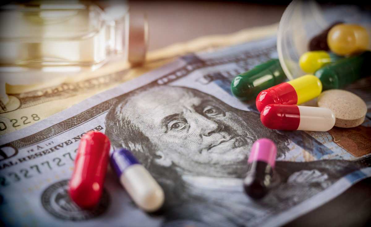 Pills scattered on US money.