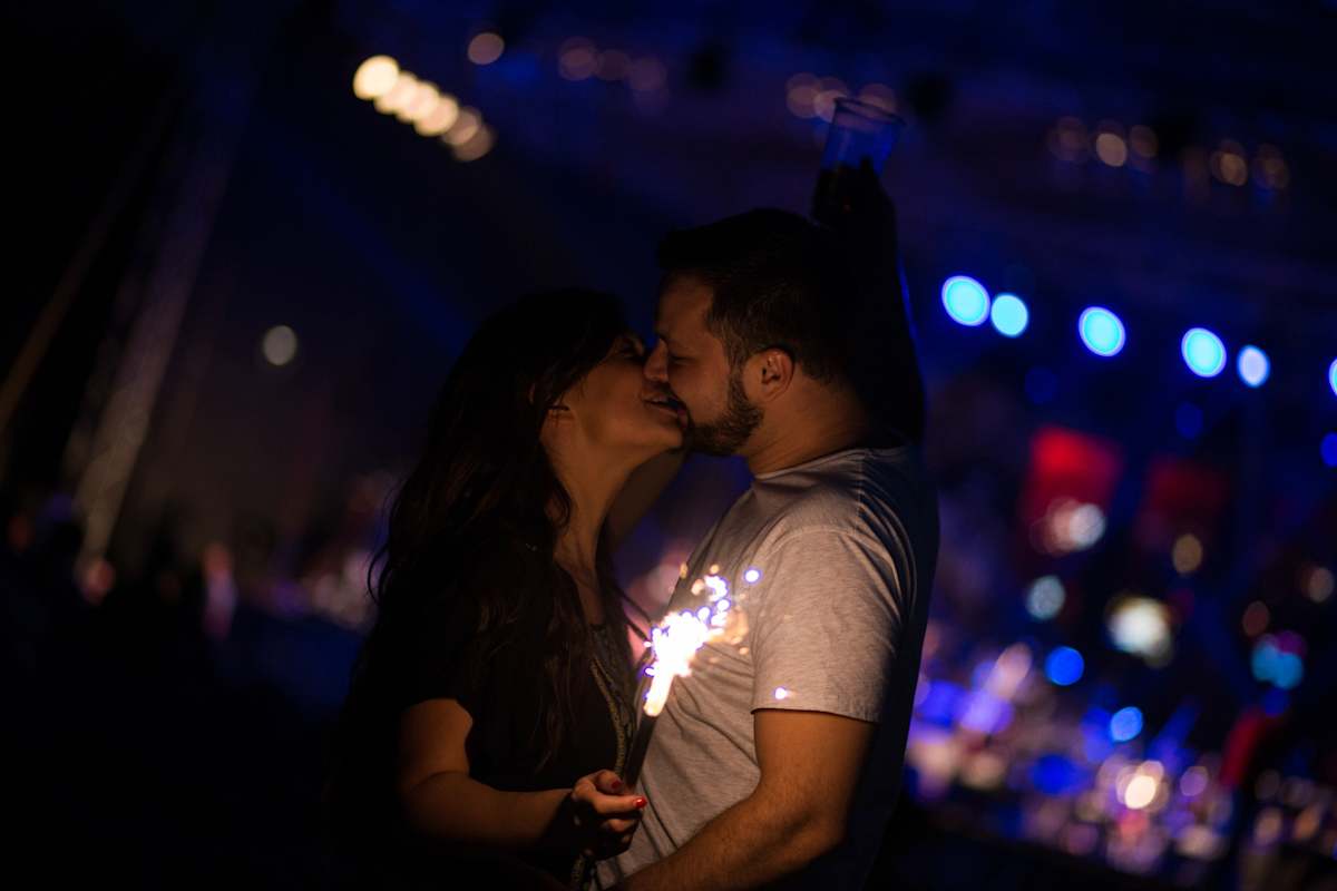 Couple kissing at a concert.