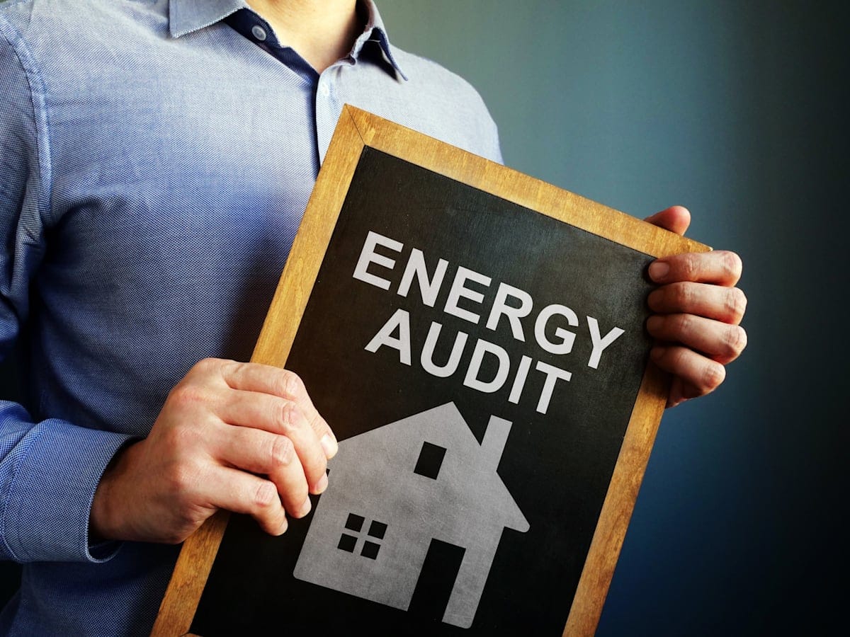 Man holds Energy Audit board.