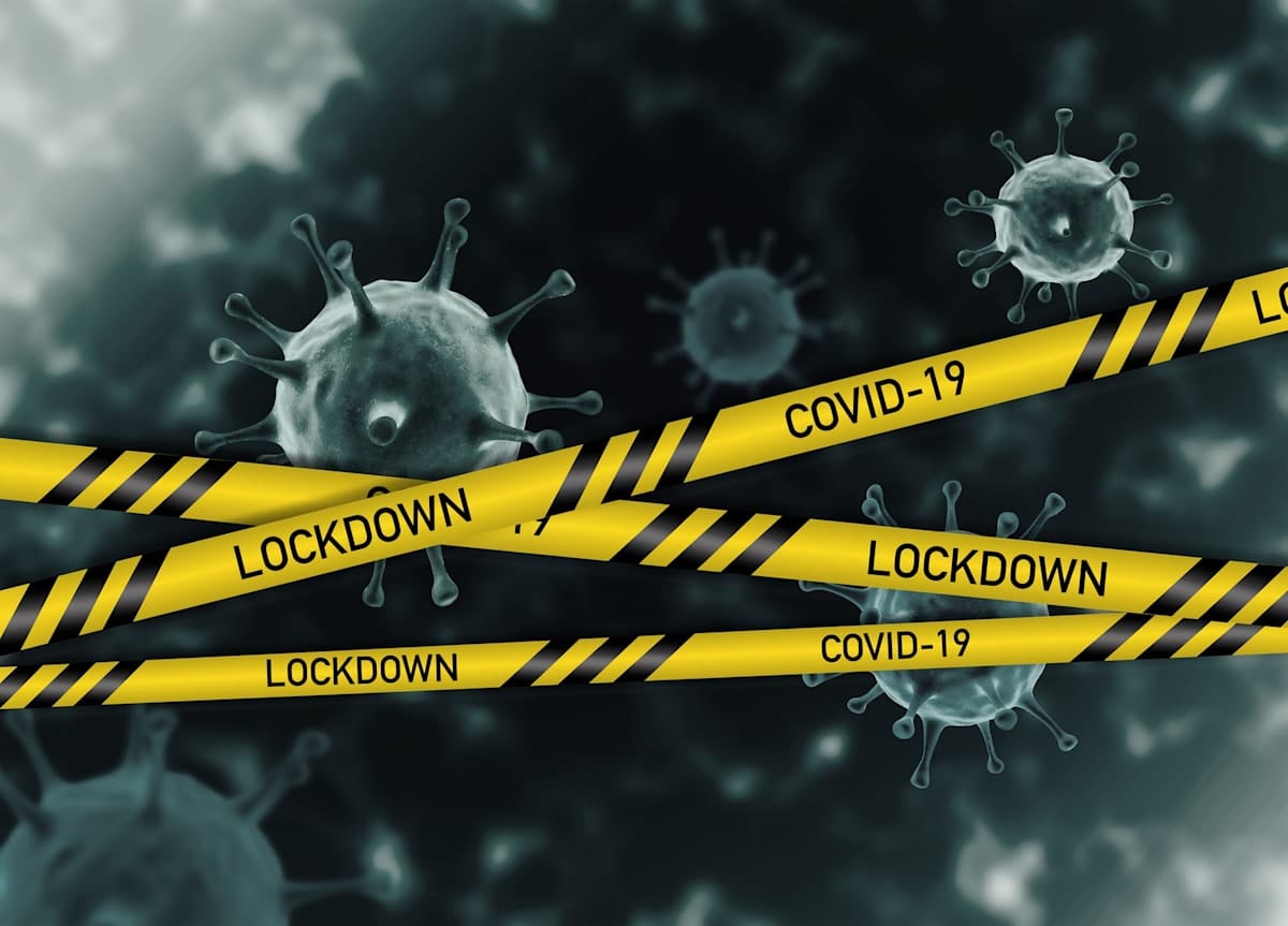 Lockdown tape with COVID-19 virus illustration.