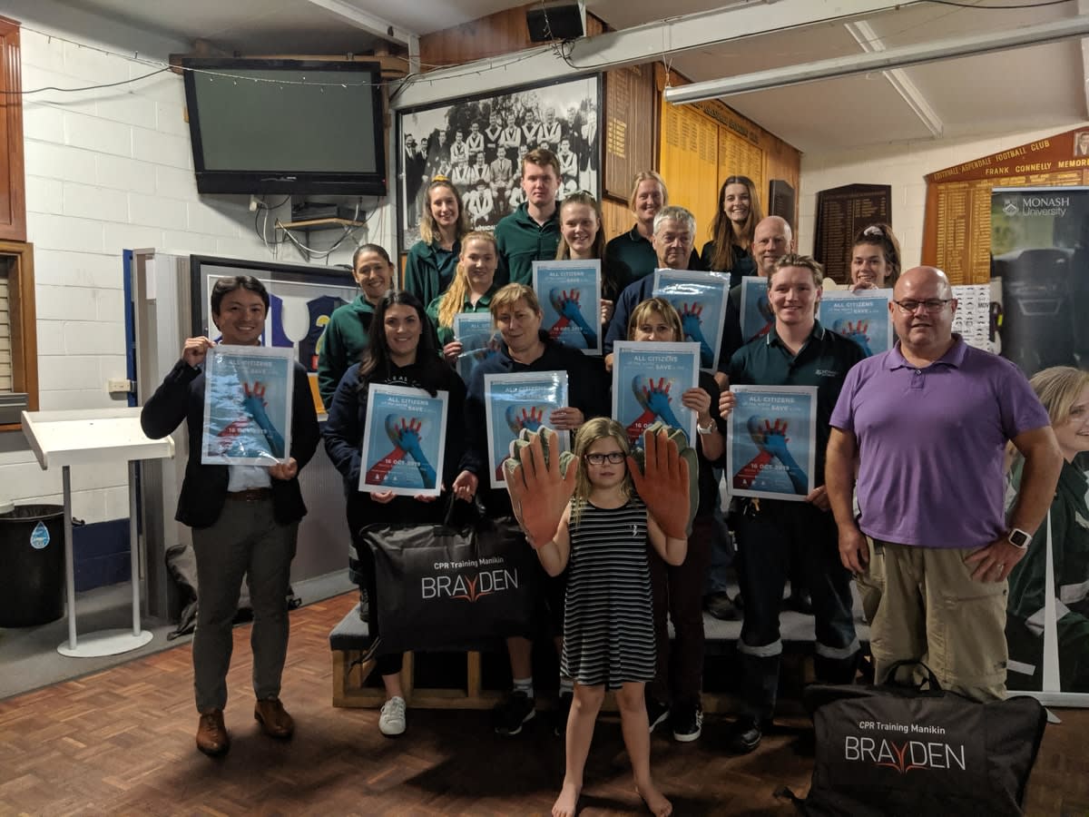 Paramedicine students and Edithvale netball club members smiling and displaying their CPR course certificates
