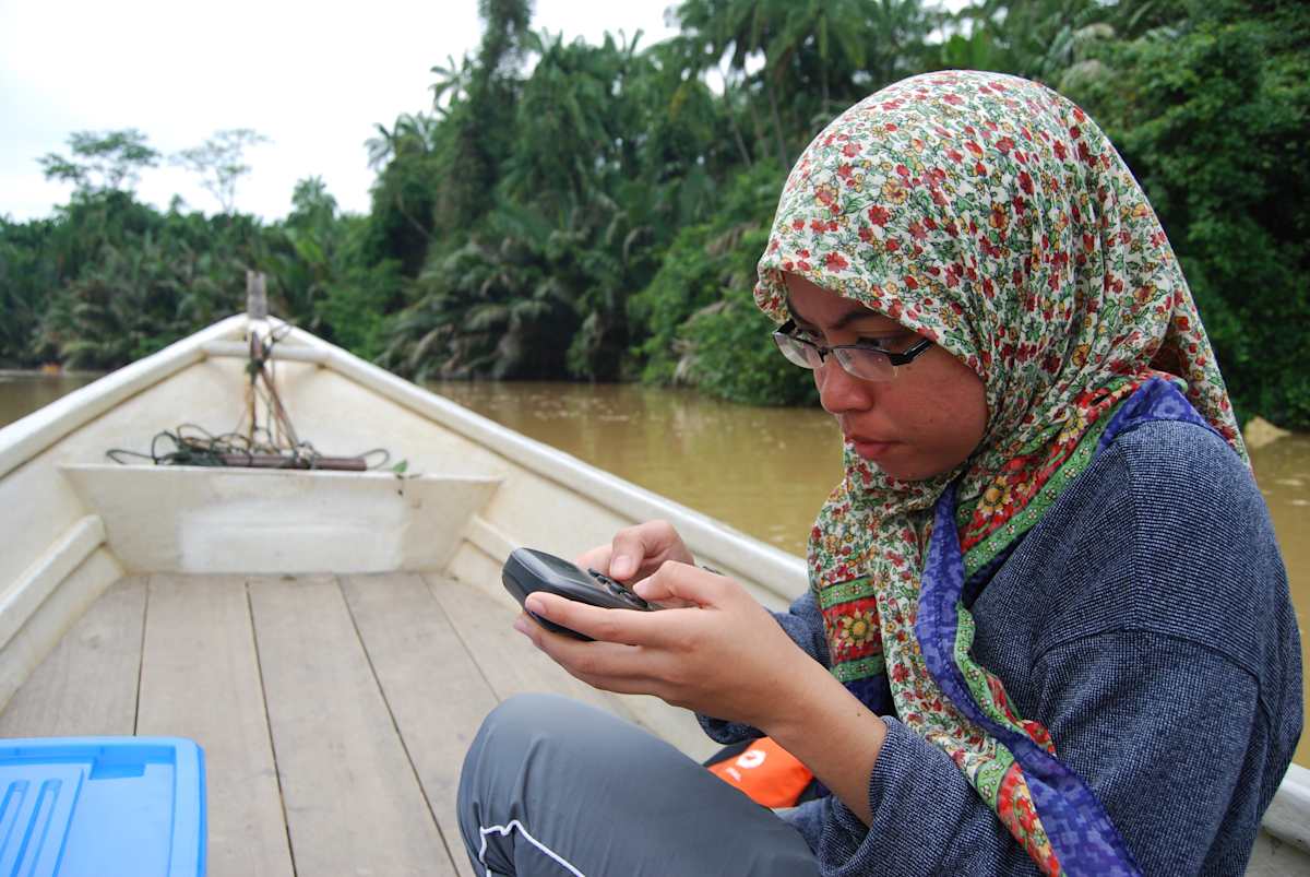 Wan Faridah on a boat on a field trip.
