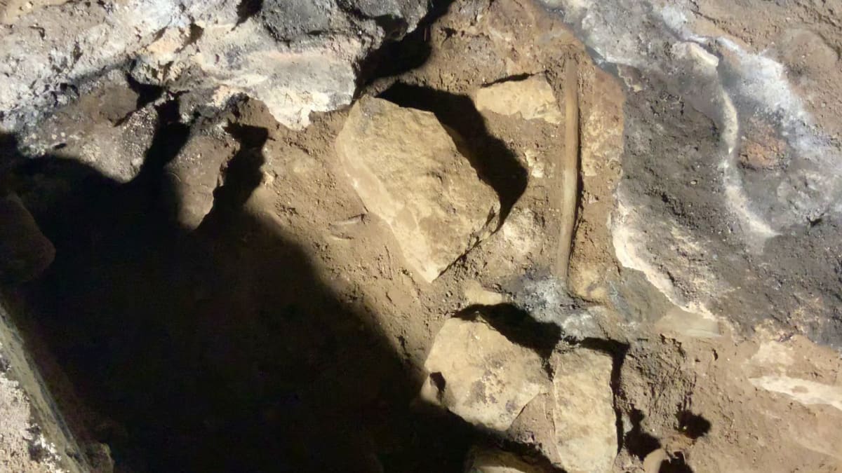One of the fireplaces inside Cloggs Cave and one of the ritual sticks. Photo: Courtesy 