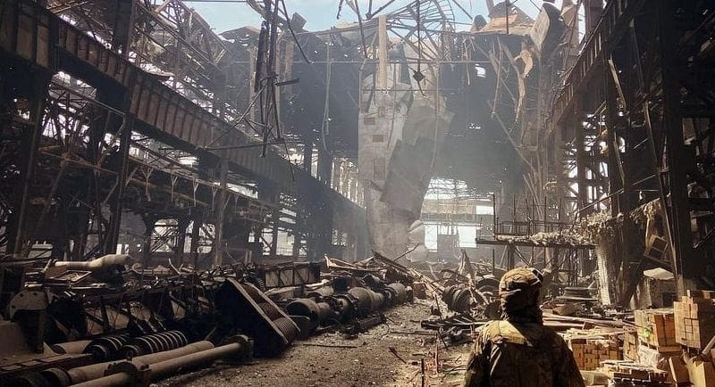 A soldier examines the destruction of the Azovstal steel factory in Mariupol, Ukraine the 
