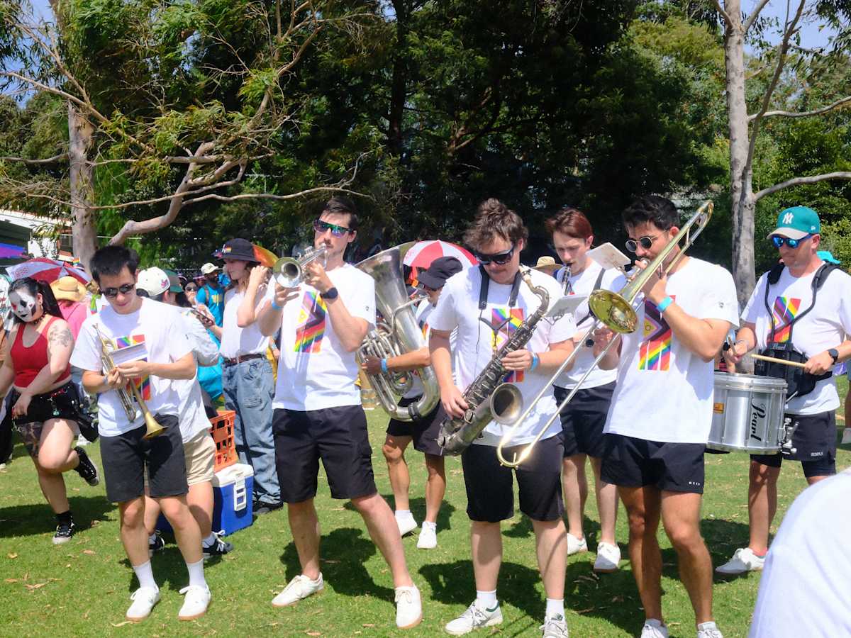 A Monash University brass band gets into the swing of the Midsumma Pride March.